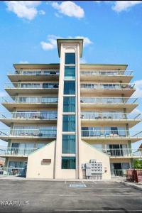 a large apartment building with a tall building at River Place Condos #711 3BD in Pigeon Forge
