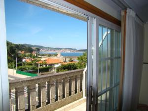 a balcony with a view of the ocean at Hotel Miramar Playa America Nigran in Nigrán