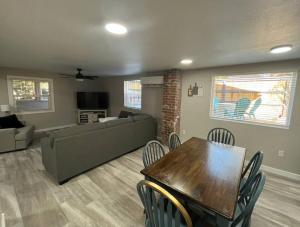 a living room with a couch and a table and chairs at Downtown Rustic Roots in Chico