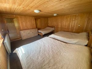 1 dormitorio con 2 camas en una cabaña de madera en Солонець, en Chereshenka