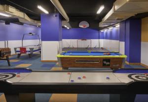 a pool table in a room with purple walls at Ottawa Marriott Hotel in Ottawa