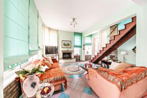 a living room with two couches and a staircase at Casa dei fiori in Corfu