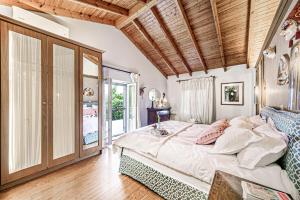 a bedroom with a large bed with a wooden ceiling at Casa dei fiori in Corfu +61 photos