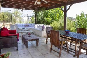 un patio con sofá, mesa y sillas en Comfortable Triplex 5 Min to the Beach with Garden in Bodrum, en Bodrum City