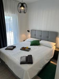 a large white bed with a tray of food on it at Iris apartment in Vižinada