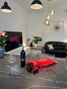 a table with a bottle of wine and a glass at Iris apartment in Vižinada