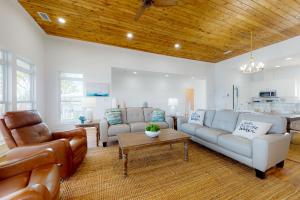 a living room with a couch and a table at Sunset Bay in Dauphin Island