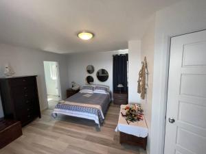 a bedroom with a bed and a table in it at Maison sur le lac in Desbiens