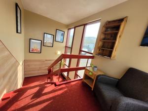 a living room with a couch and a stair case at Grundarfjordur Bed and Breakfast in Grundarfjordur