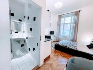 a white bathroom with a bed and a sink at Black & White Flat for 2 / Peaceful / Jewish Quarter in Prague