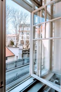an open window with a view of a city street at Black & White Flat for 2 / Peaceful / Jewish Quarter in Prague