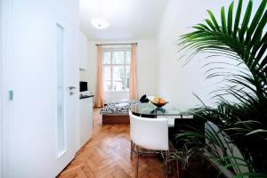 a white room with a table and a plant at Black & White Flat for 2 / Peaceful / Jewish Quarter in Prague