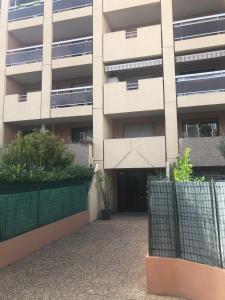 an apartment building with a gate in front of it at Charment appartement à Marseille - Prado A/C in Marseille