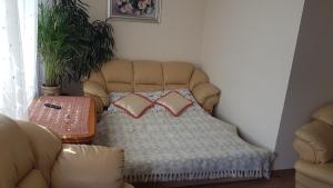 a couch with two pillows on it in a room at Topolowa 13 in Mińsk Mazowiecki