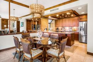 a kitchen with a dining room table and chairs at Mauna Lani Terrace J101 in Waikoloa