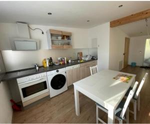 a kitchen with a white table and a white stove top oven at Ferienwohnung Idarblick in Idar-Oberstein