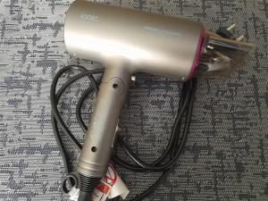 a hair dryer with a cord plugged into it at Kandavas Apartments in Daugavpils