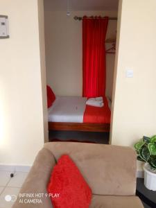 a small room with a couch and a bed at Lux Suites Racecourse Gardens Studio Apartments in Nairobi +11 photos