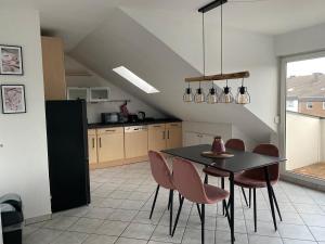 a kitchen with a dining room table and chairs at FeWo Gladbeck in Gladbeck