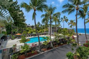 an aerial view of a resort with a pool and palm trees at Alii Villas 309 in Kailua-Kona