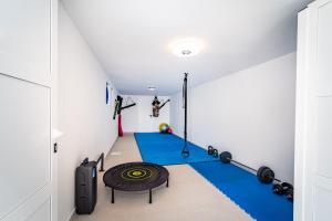 a room with a gym with blue mats at Villa A in Novigrad Dalmatia