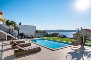 a swimming pool on the roof of a house at Villa A in Novigrad Dalmatia