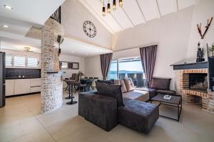 a living room with a couch and a fireplace at Villa A in Novigrad Dalmatia