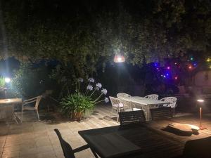 a patio with a table and chairs at night at Bed&Breakfast Vanni in Privlaka