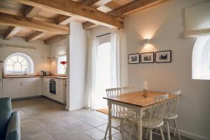 a kitchen and dining room with a table and chairs at Försterei in Barkelsby