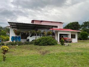 a house with a car parked in front of it at Mi Casita Campersite in Armenia