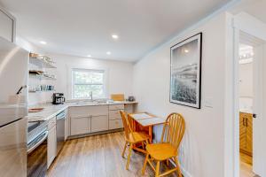 a kitchen with a table and two chairs in it at Shorelands 44-1 in Kennebunk