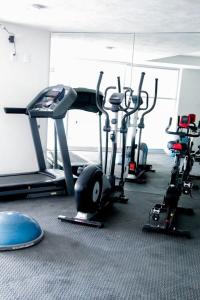 a gym with several cardio bikes and tread machines at Comfort Flat In Guadalajara in Guadalajara