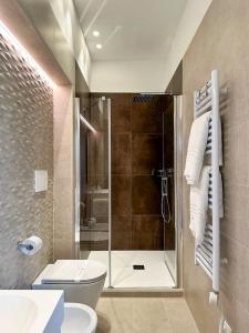 a bathroom with a shower with a toilet and a sink at Iblu Rooms in Termoli
