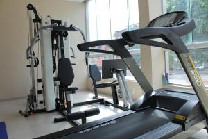 a gym with two tread machines and a treadmill at Resende Inn in Resende