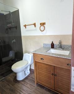 a bathroom with a toilet and a sink at El Sitio Village in Playa Venao