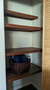 a shelf with a basket on it in a closet at El Sitio Village in Playa Venao