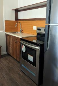 a kitchen with a stainless steel stove and a sink at El Sitio Village in Playa Venao