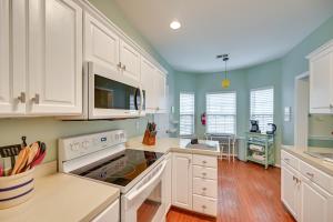 a kitchen with white cabinets and blue walls at Gorgeous Lexington Retreat about 2 Mi From UK! in Lexington