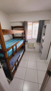 a small room with two bunk beds in it at Condomínio mais Maracanã B1 AP 708 in Rio de Janeiro