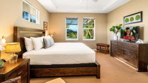 a bedroom with a bed and a television in it at Waikoloa Beach Villas N32 in Waikoloa +34 photos