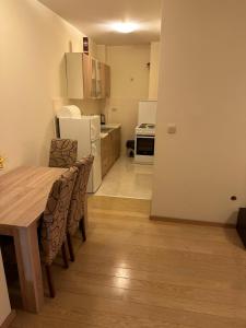 a kitchen and dining room with a table and chairs at Clarissa apartment City Kvart in Podgorica