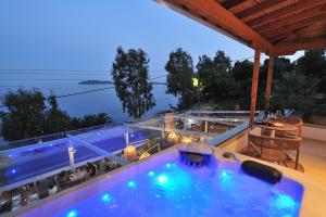 a swimming pool on the roof of a house at Salty Wave Suites in Skiathos