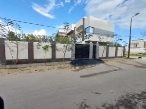 a house with a gate in front of a street at Villa Bakr in Naj‘ al Aḩwāl