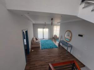 a living room with a couch and a mirror at Villa Bakr in Naj‘ al Aḩwāl