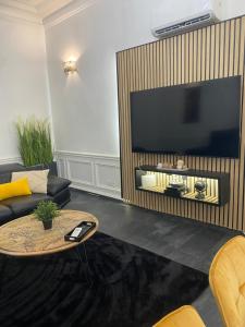 a living room with a large flat screen tv at Pyramide in Mulhouse