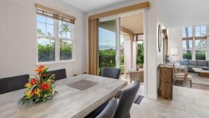 a dining room with a wooden table and chairs at Waikoloa Colony Villas 1702 in Waikoloa