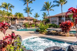 a pool at a resort with palm trees at Waikoloa Colony Villas 1702 in Waikoloa