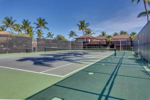 a tennis court with palm trees in the background at Waikoloa Colony Villas 1702 in Waikoloa