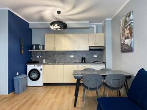 a kitchen with a table and chairs in a room at B2B Apartments in Jihlava