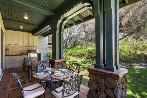a patio with a table and chairs on a porch at Kulalani at Mauna Lani 205 in Waikoloa